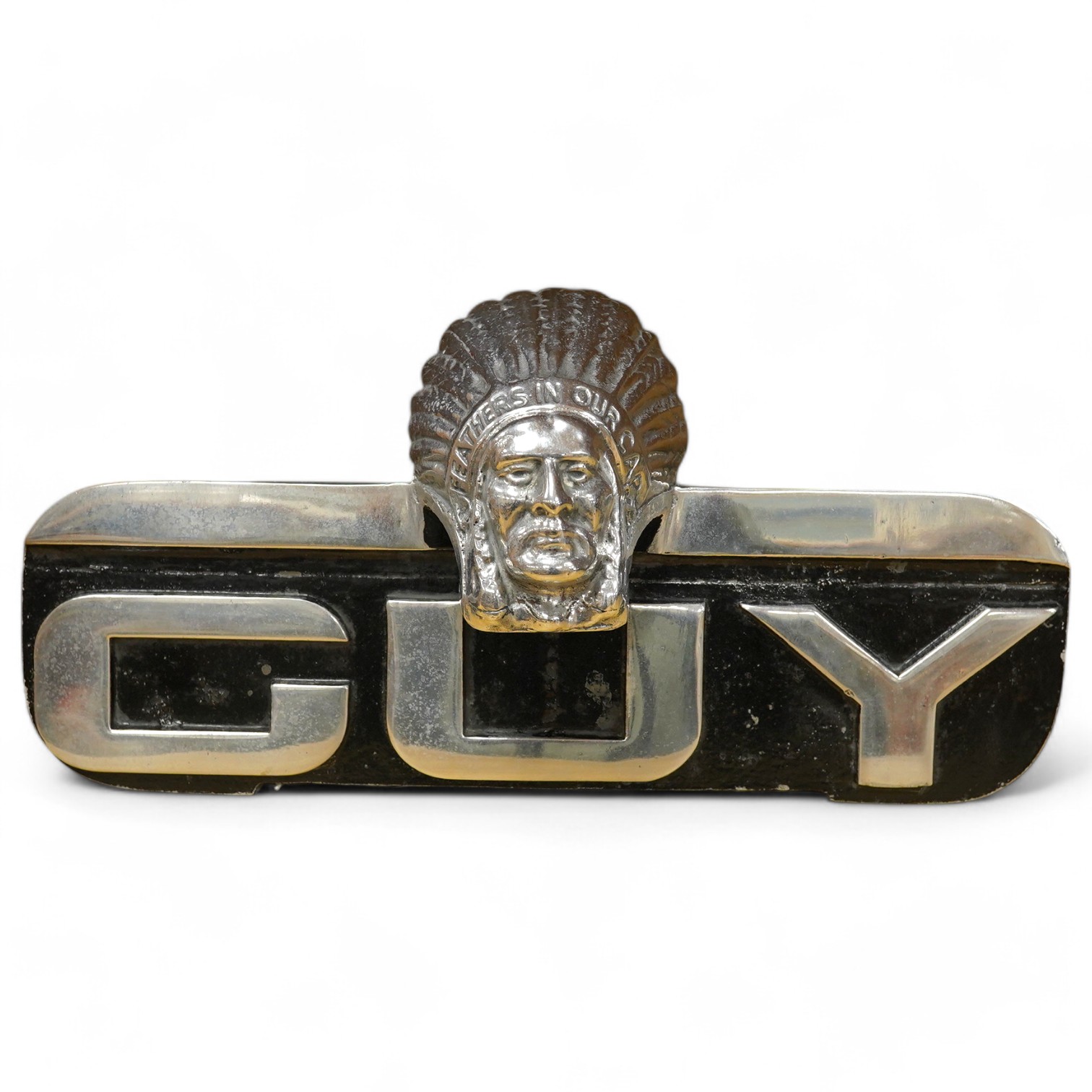 A 1960s Guy Motors aluminium truck radiator badge, bearing the legend; ‘Feathers in Our Cap’, 32.5cm wide. Condition - fair.